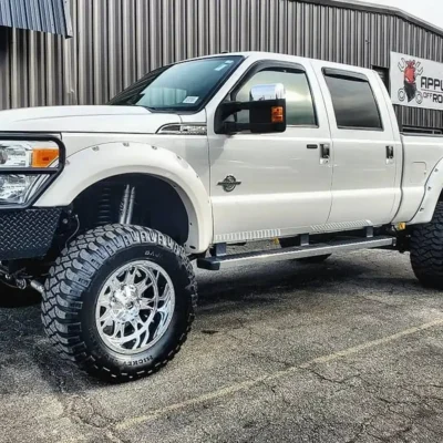 A custom-built Ford F-350 on aftermarket wheels and tires.