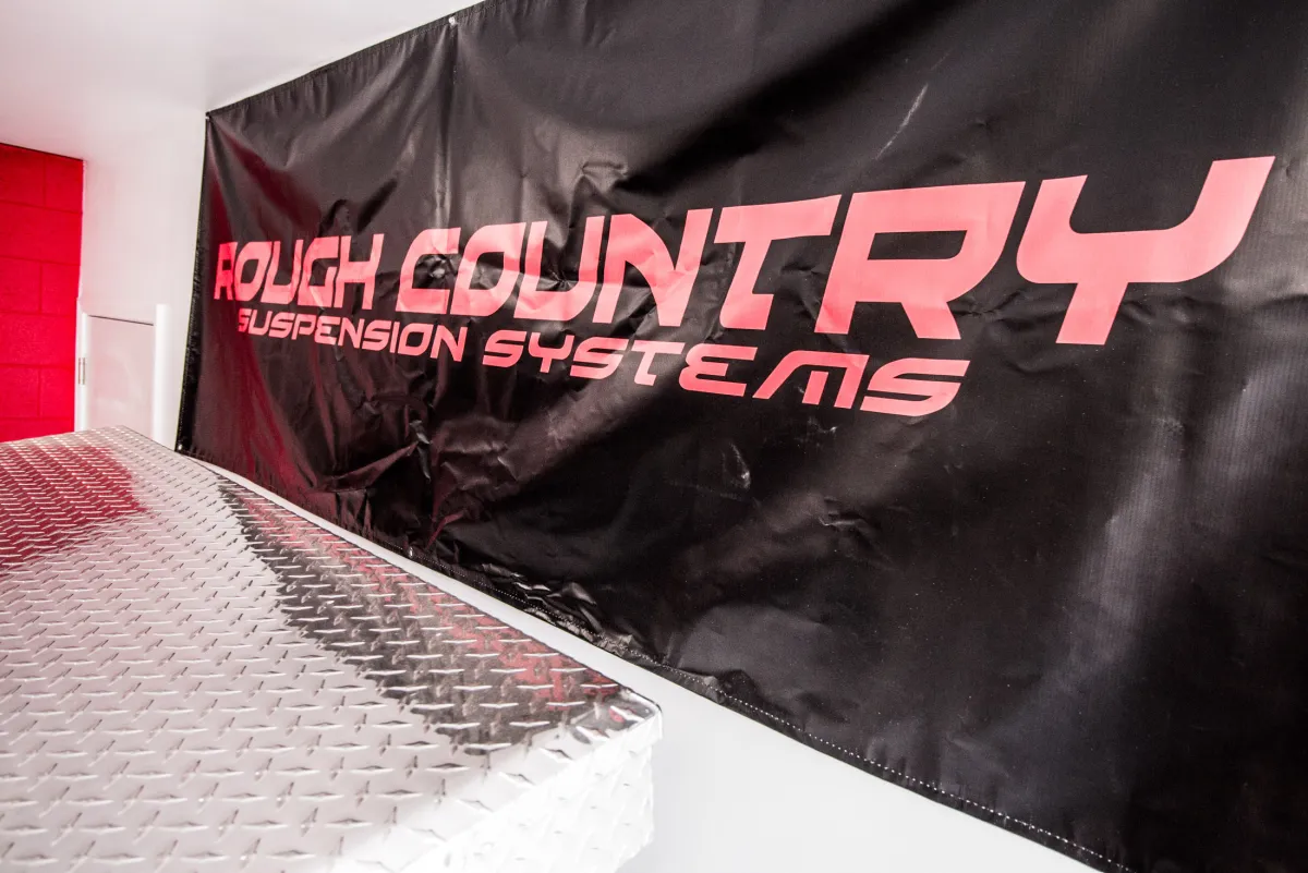 The Rough Country Suspension Systems dealer banner inside the Apple Off Road shop.