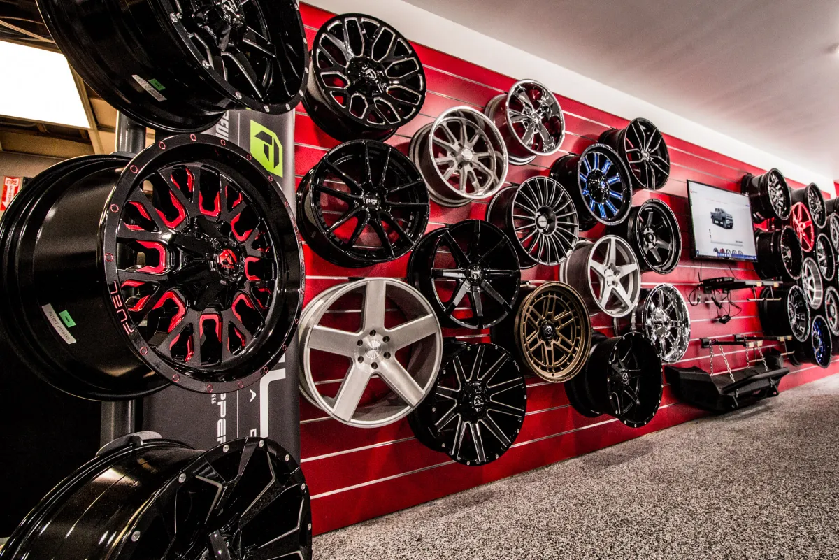 The in-shop wheel display wall at Apple Off Road, stocked with aftermarket off-road wheels.